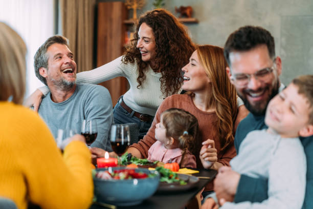 istock Happy extended family celebrating Thanksgiving at dining table. 2185423120