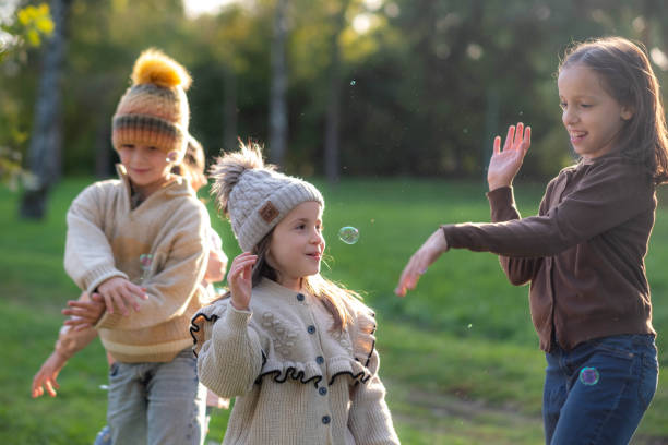 istock children play with soap bubbles, enjoy and are happy 2185423754
