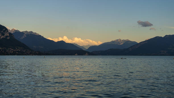 istock Alpine lake at sunset with mountains in the background 2185423791