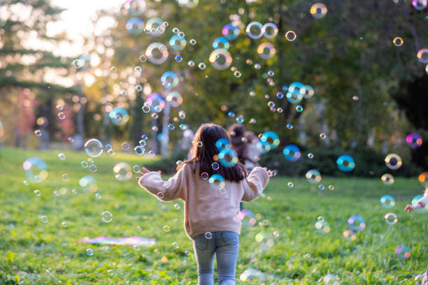 istock children run through soap bubbles in the meadow 2185424043