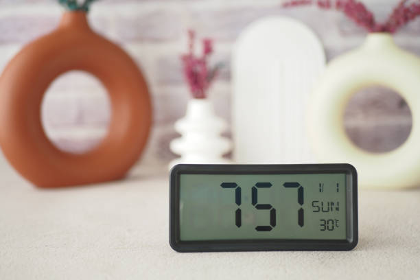 istock A modern digital clock designed elegantly alongside beautiful decorative vases in soft colors 2185424569