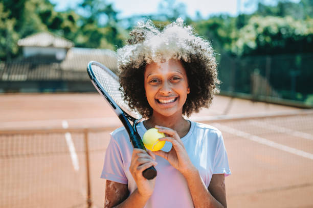 istock child playing tennis 2185425644