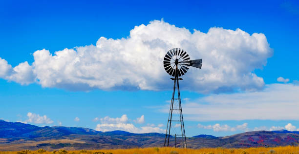Windmill on Hillside in Countryside Rural America with Sky and Clouds