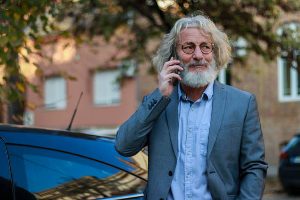 istock Silver senior businessman close car 2185426908