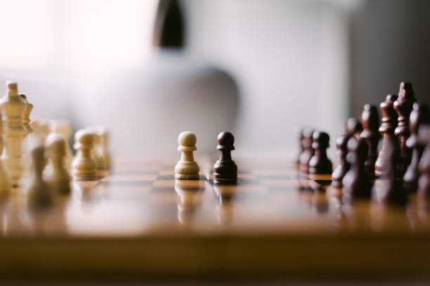 istock A chess board with a white pawn and a black pawn on it 2185426981