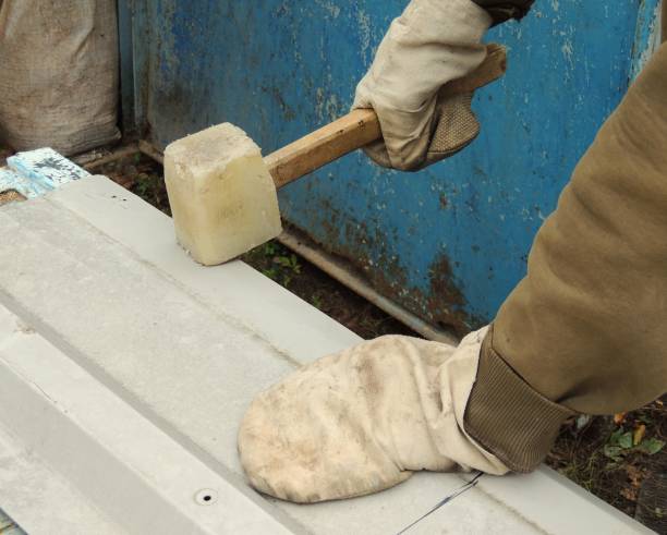 istock A person straightens or bends a metal sheet with a mallet 2185430407