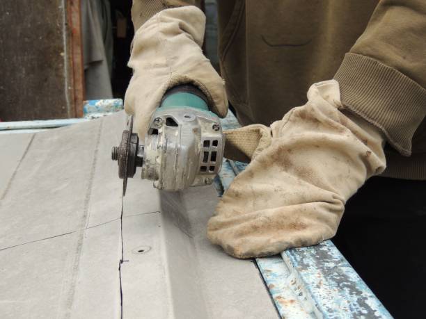 istock A man cuts a metal plate with a grinder. 2185430434