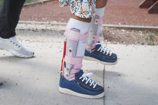 istock Child cerebral palsy disability, legs orthosis. 2185430902
