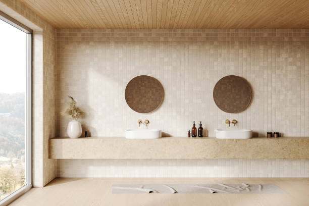 istock Minimalistic bathroom interior with twin sinks and round mirrors on a tiled wall, natural light from a large window. 3D Rendering 2185433664