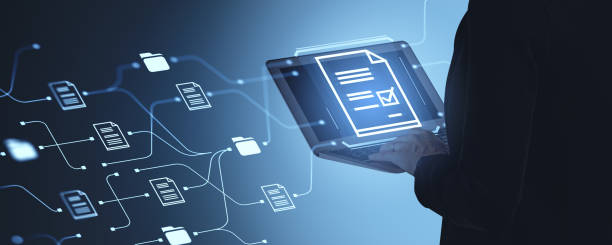istock Woman typing on laptop, document management system and files hologram 2185433698