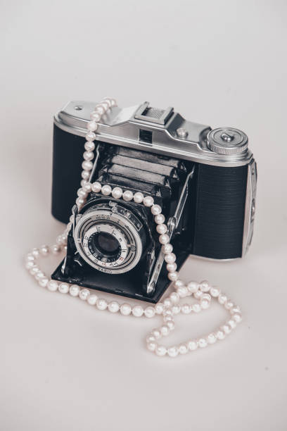 istock A camera with a pearl necklace on it 2185435385