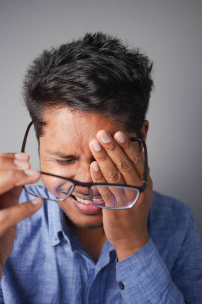 istock upset man suffering from strong eye pain 2185437615