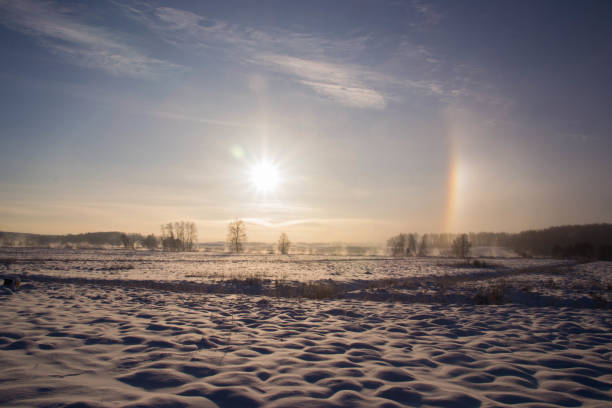 istock Sun halo over a snowy field 2185438083