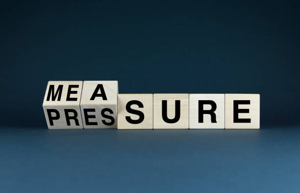 istock Wooden blocks spelling out Measure and Pressure 2185438215