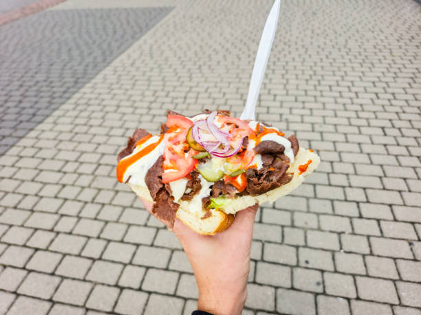 istock Tasty doner kebab in man hand. 2185439847