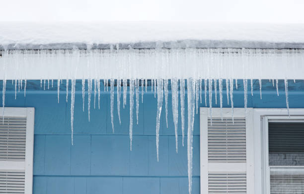 istock icicle hanging on house roof 2185440248