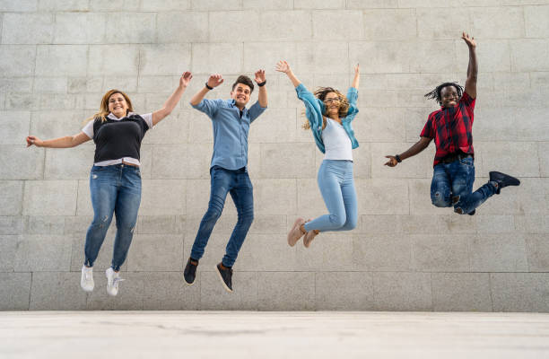 istock Happy friends jumping together outdoor 2185442974