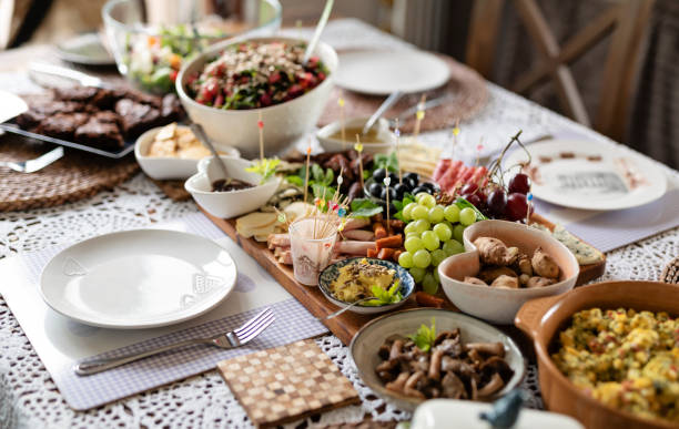 Breakfast ready to eat on a table. Homemade food for lunch on a plate with table setting. Salad bowl with sauce, vegetable, ham and cheese. Healthy eating at home. Close-up