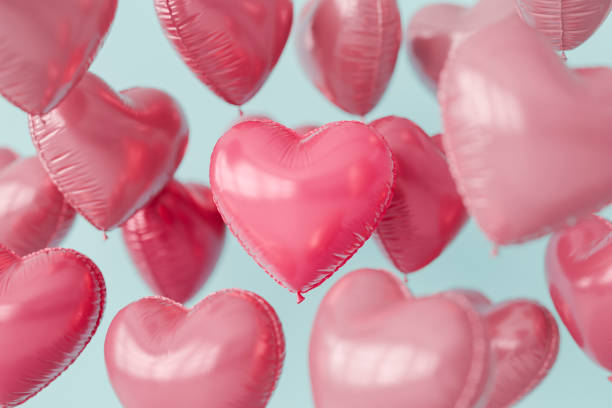 Pink heart shaped balloons floating against a light blue background. 3d rendering