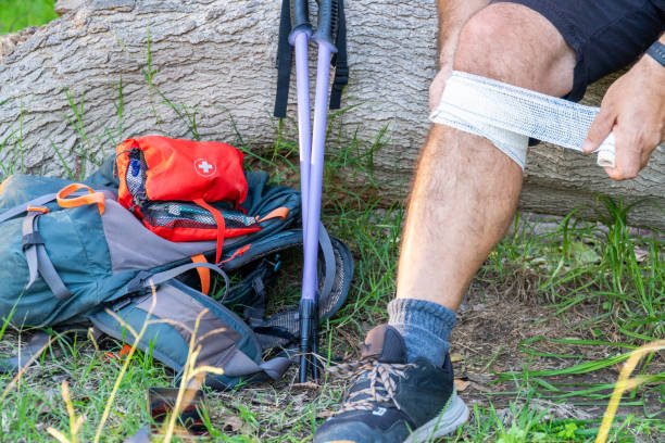 istock hiker bandaging injured knee 2185444023
