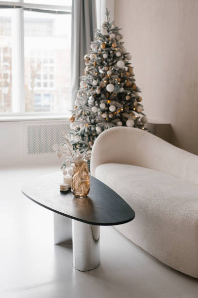 istock White couch is in front of a Christmas tree in modern living room 2185444319