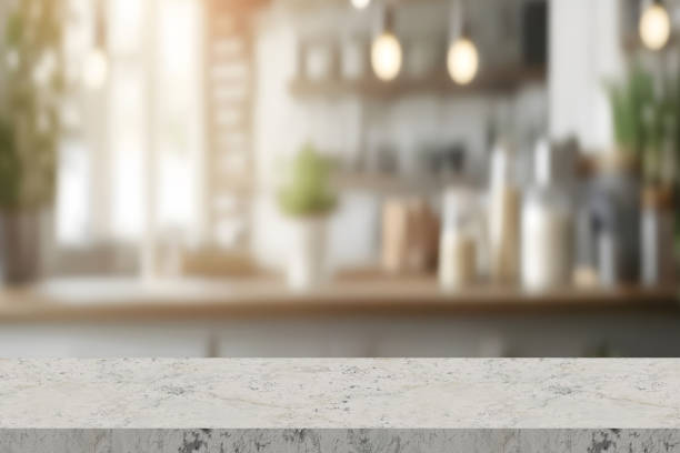 istock Empty stone white table the bright interior of the kitchen as a blurred background behind the bokeh 2185444977