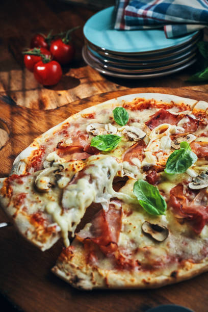 istock Pizza with Prosciutto Cotto Ham and Mushrooms 2185445543