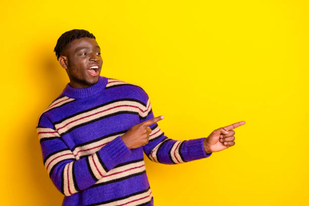 istock Photo of nice young man point fingers empty space wear pullover isolated on yellow color background 2185445914