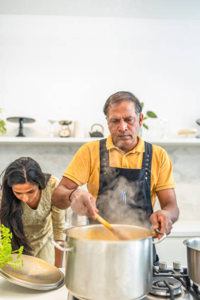 istock Expert Indian Chef Prepares Culinary Delight in Sleek Kitchen 2185448226