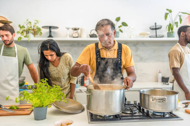 istock Indian Chef Prepares Cuisine in Modern Kitchen 2185448227