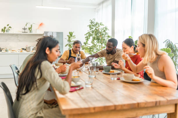 istock Joyful Cooking Class Participants Savoring Indian Cuisine in a Kitchen 2185448263