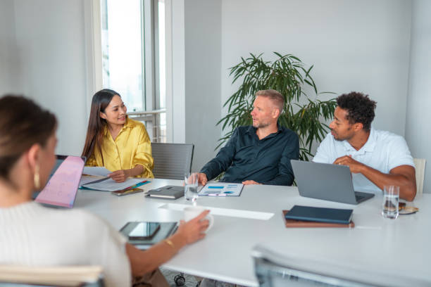 istock Diverse Team Engages in Strategic Planning at Modern Conference Table 2185449511