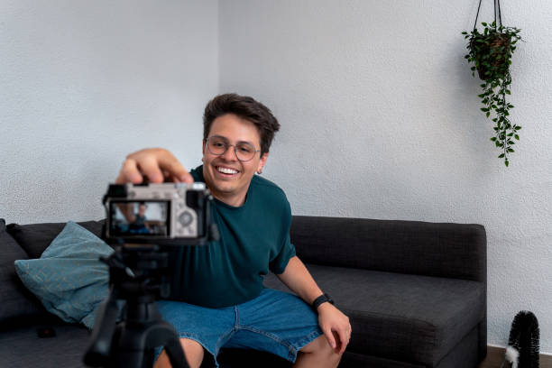 istock Happy young influencer preparing his camera before recording his vlog 2185451057