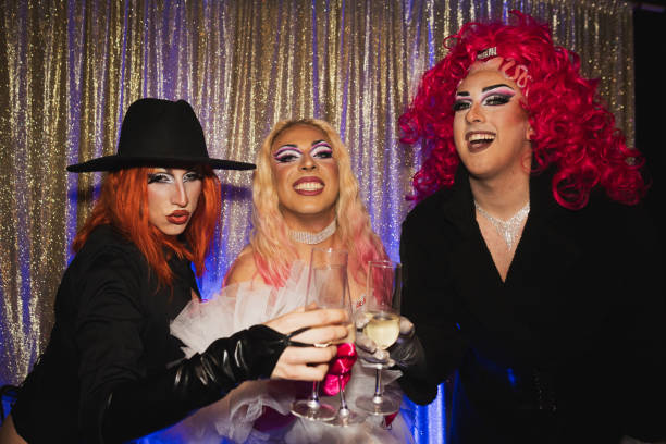 istock Drag queens toasting with champagne flutes at party 2185451499