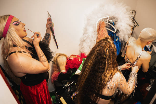 istock Drag queens preparing for show in dressing room: applying makeup and costumes 2185451525