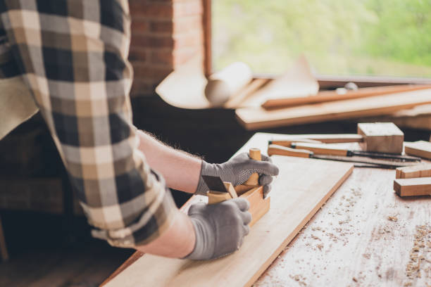 istock Cropped photo of joiner guy using tool working with wood plank in garage 2185451935