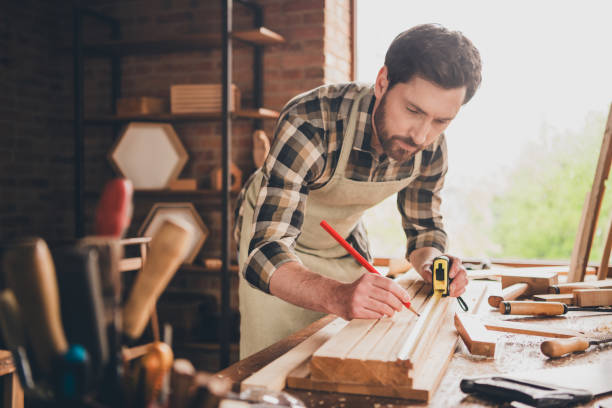 istock Photo of engineer master professional wood worker man concentrated write size measures with ruler and pencil indoors workshop 2185452043