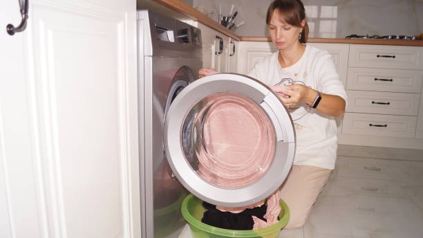 istock Housekeeping.Woman doing laundry in the kitchen 2185453209