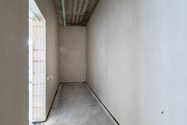 istock The room is under construction with a rough finish, plastered walls, concrete floor. 2185453398