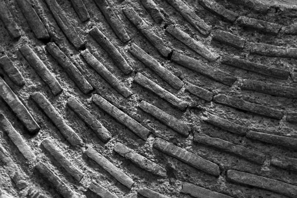 Dark gray brick wall, background photo texture, round pattern