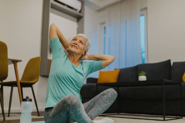 istock Senior woman stretching on an exercise mat at home 2185454848