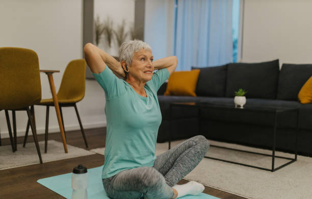 istock Senior woman stretching on an exercise mat at home 2185454870