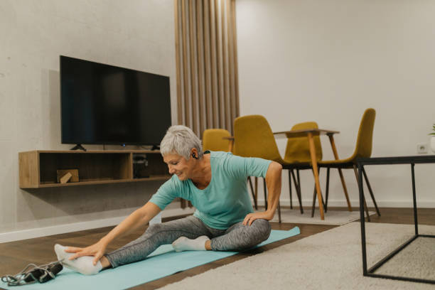 istock Senior woman stretching on an exercise mat at home 2185454871