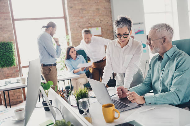 istock Photo of teamwork startup partners teambuilding discuss comfortable nice creative startup office loft room interior 2185454937