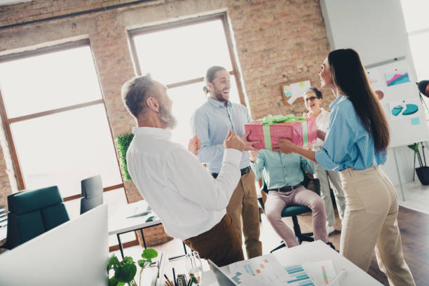 istock Photo of teamwork people working together congratulation birthday gift comfortable modern office loft room interior indoors workspace 2185454976