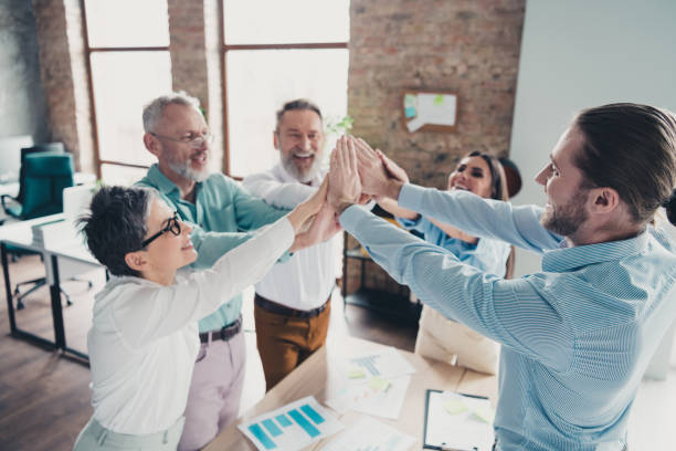 istock Photo of coworking project teamwork people highfive hold hands support work together conference meeting successful nice light office 2185455643