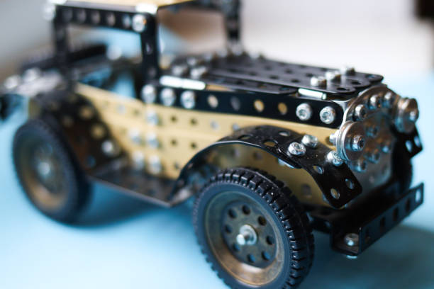 Metal designer car for children ,a place for text or design steel mechanical constructor set on blue background.the concept of the development of creativity. High quality photo