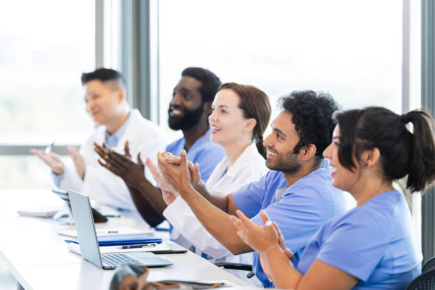 istock Medical seminar attendees applaud after speech 2185457625