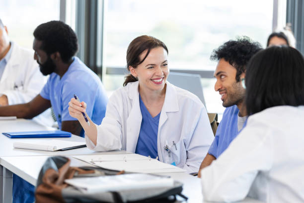 istock Happy female medical student talking with classmates 2185457665