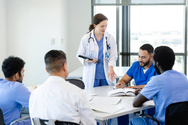 istock Female medical school professor assists students 2185457720